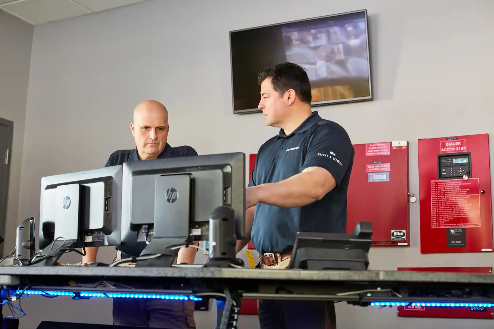 data center security personnel monitoring entrance access systems