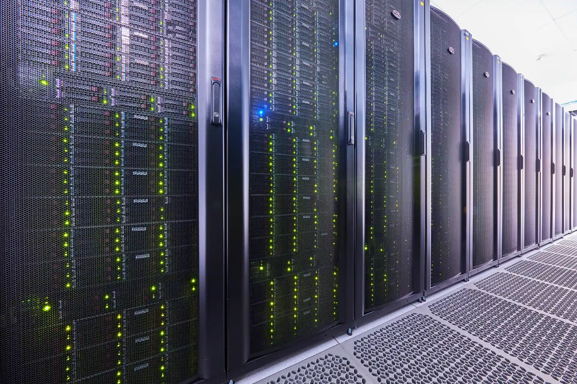 rows of data center server racks with active equipment and network infrastructure