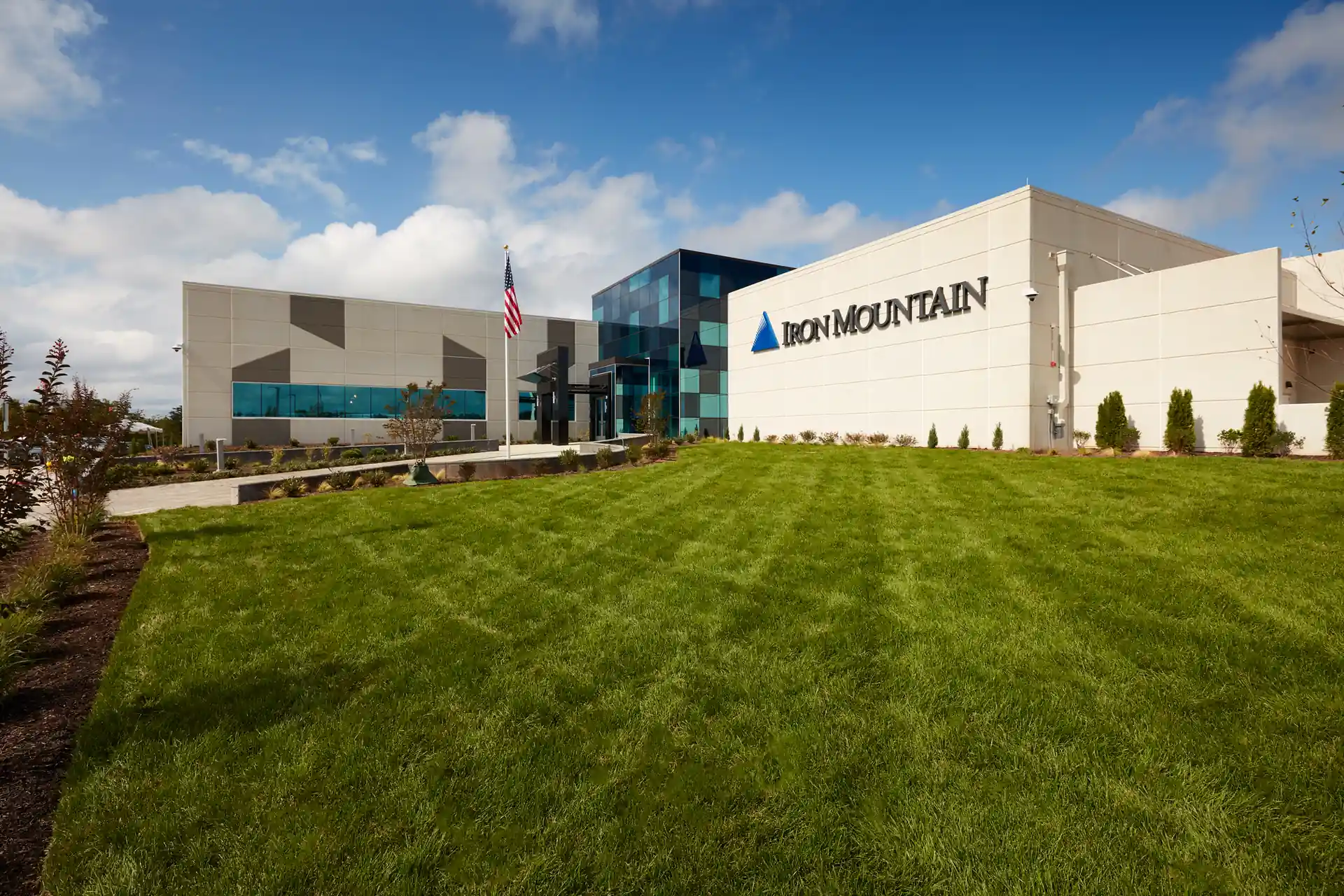 modern data center facility exterior with landscaped grounds and corporate branding