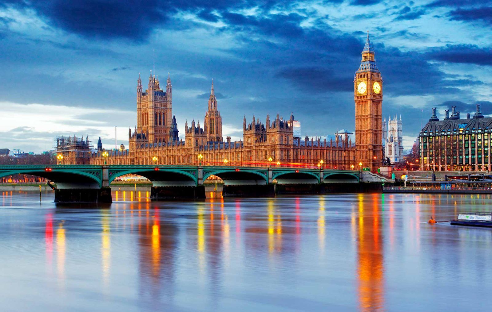 London skyline at dusk with illuminated buildings along the River Thames, used as a regional context image for data center photographer services.