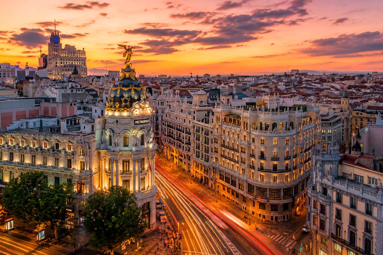 Madrid city center at dusk with illuminated buildings and urban traffic, used as a regional context image for data center photographer services.