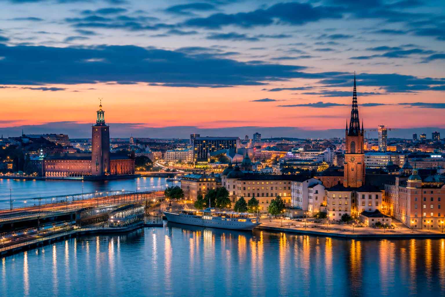 Stockholm waterfront skyline at dusk with illuminated historic and modern buildings, used as a regional context image for data center photographer services.